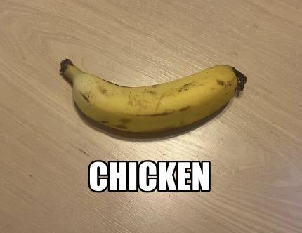 PHOTO OF A CHICKEN THAT LOOKS 100% IDENTICAL TO A BANANA ON A WOODEN TABLE. THE WORD "CHICKEN" IS BELOW IT IN THAT MEME FONT.